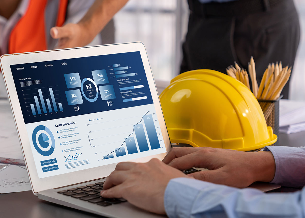 contractor monitoring revenue and data on laptop