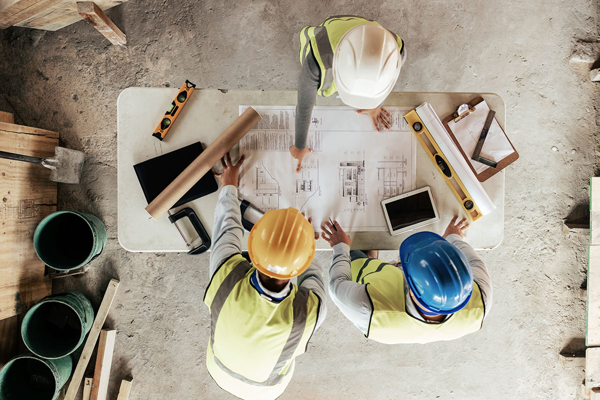 construction workers planning on blueprint